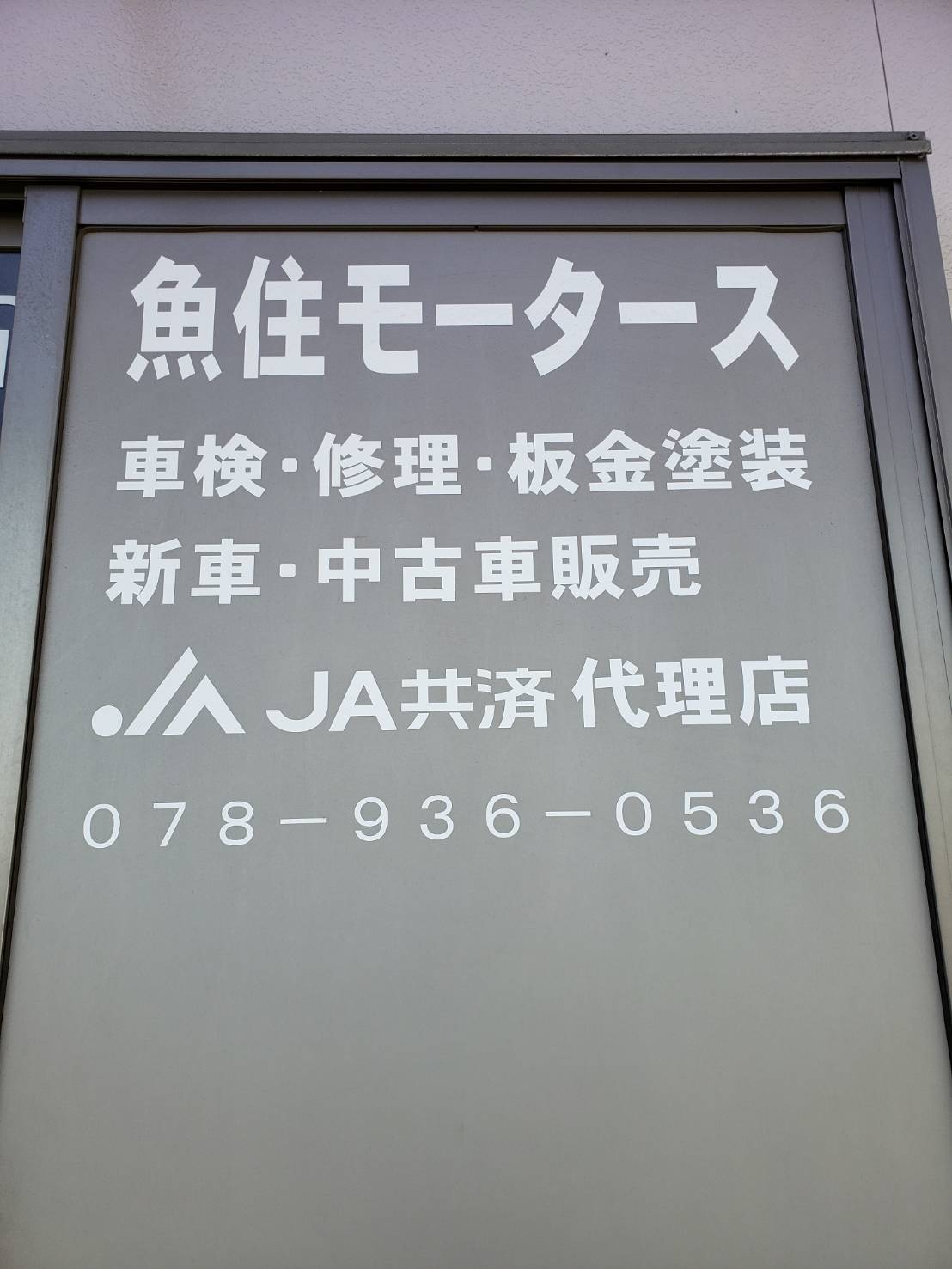 魚住モータースの看板